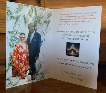 A Holiday Greeting Card with a picture of two people.