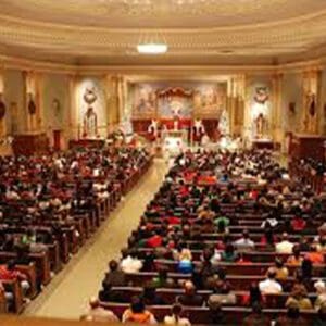 A large church with many people sitting in the church programs (4 Pages).